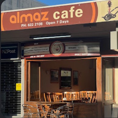 The Almaz Cafe shopfront on Onehunga Mall, with tables visible through the open front